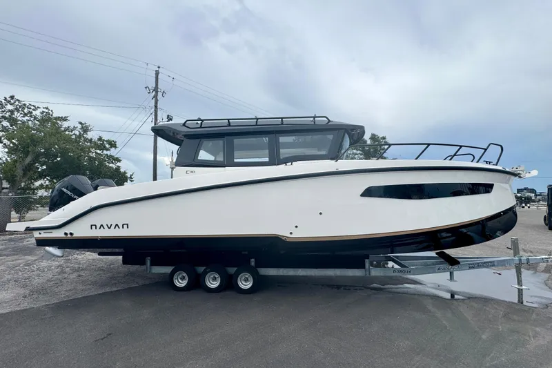 The Image of 2026 Navan C30 boat on trailer, sleek design, parked outdoors. - 0