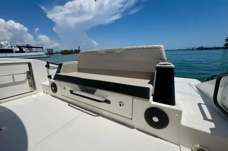 Slide: The Image of Luxury seating on 2026 Navan C30 boat, docked by serene waters under blue sky. - 10