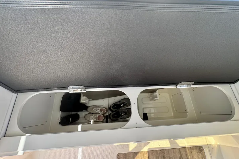 Slide: The Image of Storage compartment in 2026 Navan C30 boat, featuring organized shoe storage. - 20