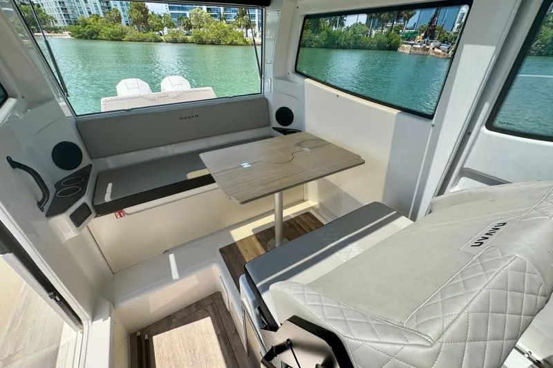 Slide: The Image of Interior of 2026 Navan C30 boat with seating, table, and scenic water view. - 23