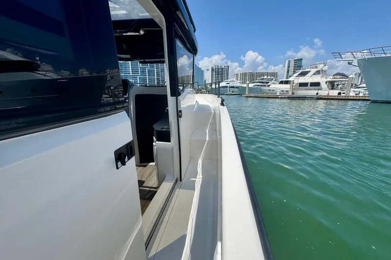 Slide: The Image of 2026 Navan C30 boat docked in marina with city skyline background. - 46