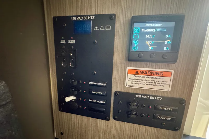 Slide: The Image of Electrical control panel in Navan C30, 2026 model, featuring inverter and warning label. - 54