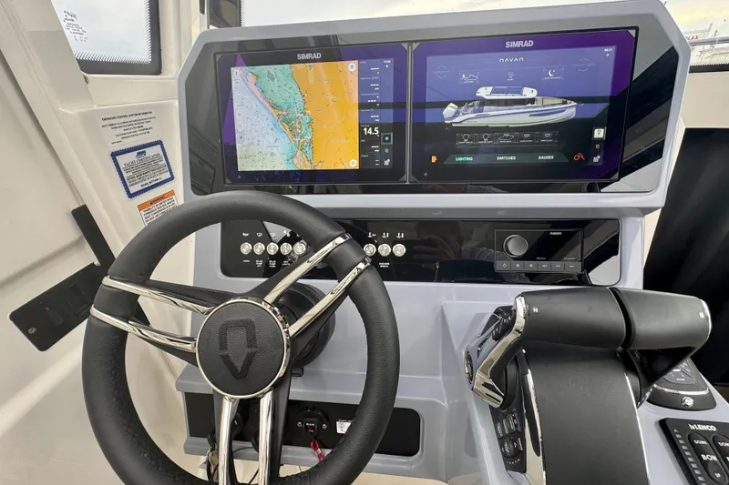 Slide: The Image of Steering console of 2026 Navan C30 boat with dual Simrad displays and modern controls. - 31