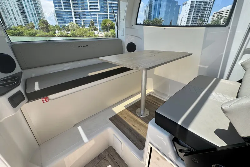 Slide: The Image of Interior of 2026 Navan C30 boat with seating and table, cityscape view. - 25