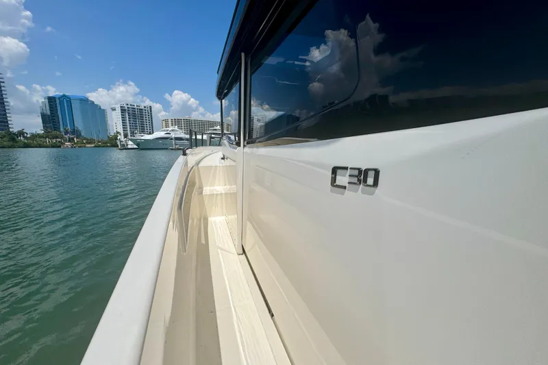 Slide: The Image of 2026 Navan C30 boat docked near modern cityscape under clear blue sky. - 45