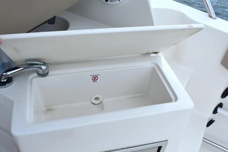 Slide: The Image of Boat sink with non-potable water sign on Sailfish 270 WAC, 2020 model. - 13