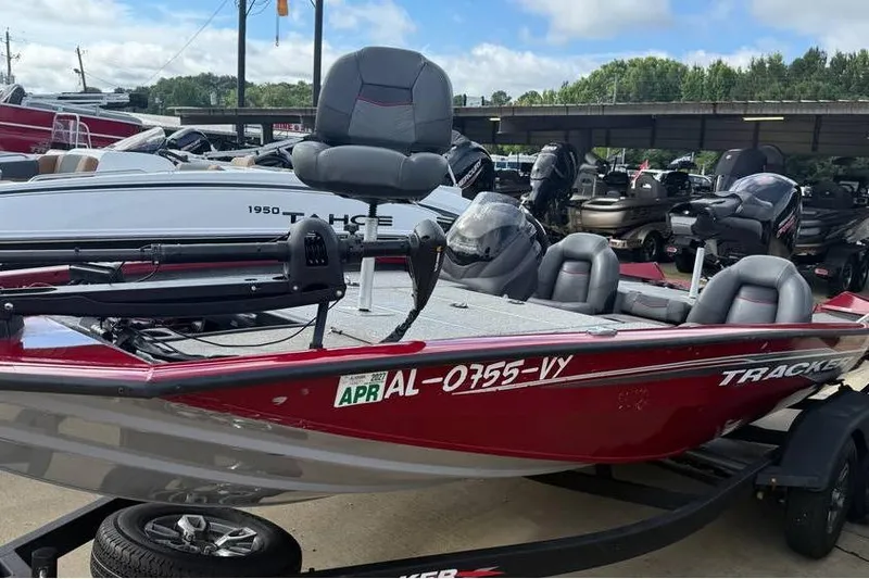 Slide: The Image of 2024 Tracker Pro Team 195 TXW Tournament Edition boat in a dealership lot. - 2