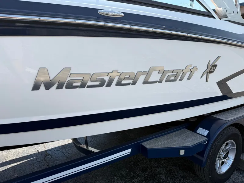 Slide: The Image of Side view of a 2016 MasterCraft X30 boat on a trailer. - 20