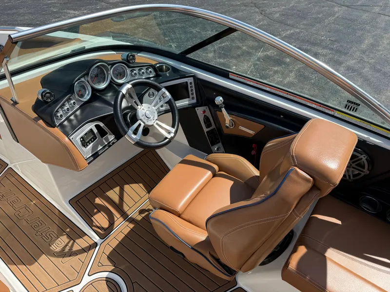 Slide: The Image of 2016 MasterCraft X30 with brown leather seats and a modern dashboard. - 41