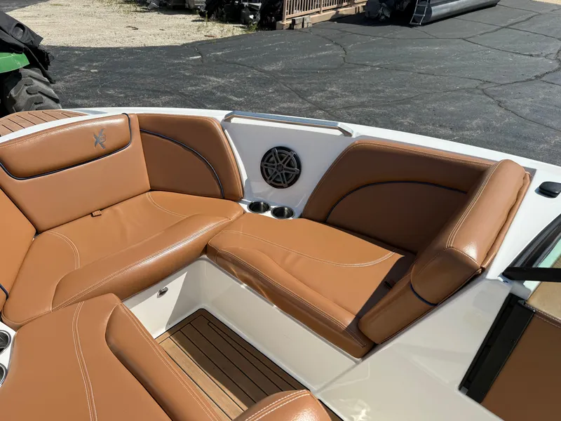 Slide: The Image of The image shows the bow area of a 2016 MasterCraft X30 with brown leather seating. - 37
