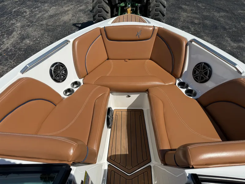 Slide: The Image of The image shows the bow area of a 2016 MasterCraft X30 with brown leather seating. - 30