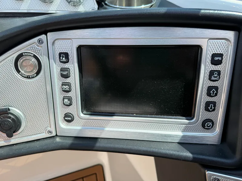 Slide: The Image of The image shows a control panel of a 2016 MasterCraft X30 boat with a screen and controls. - 42