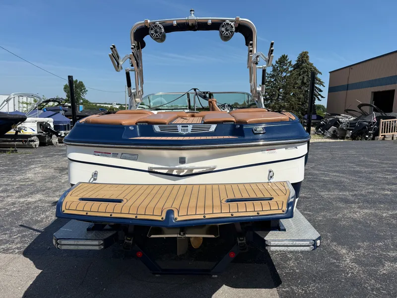 Slide: The Image of Rear view of a 2016 MasterCraft X30 with brown and white interior, parked on a lot. - 15