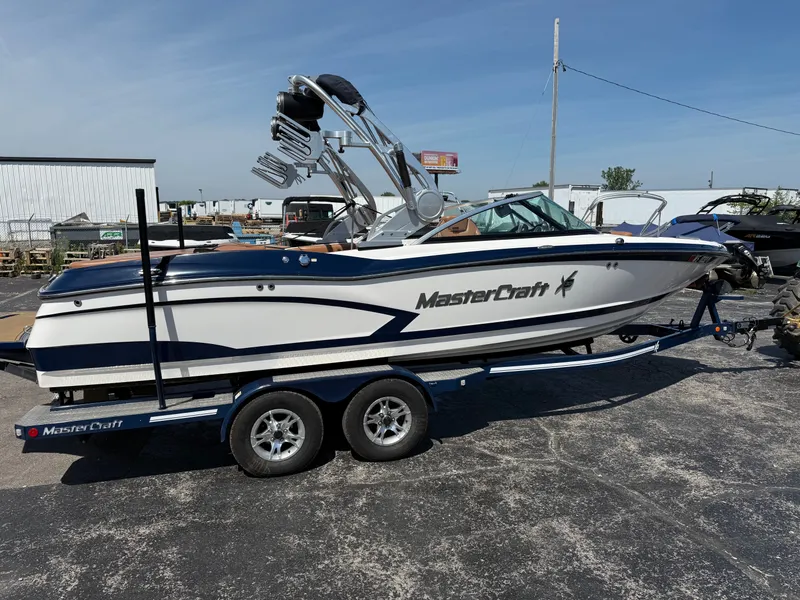 Slide: The Image of A 2016 MasterCraft X30 on a trailer, featuring a tower and blue accents. - 11