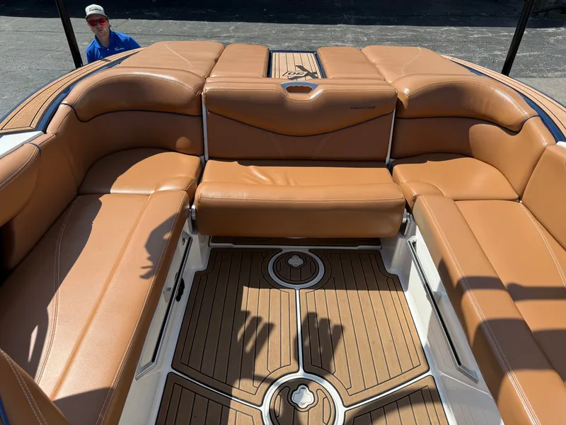 Slide: The Image of The image shows the cockpit of a 2016 MasterCraft X30 with brown leather seats and wood flooring. - 27