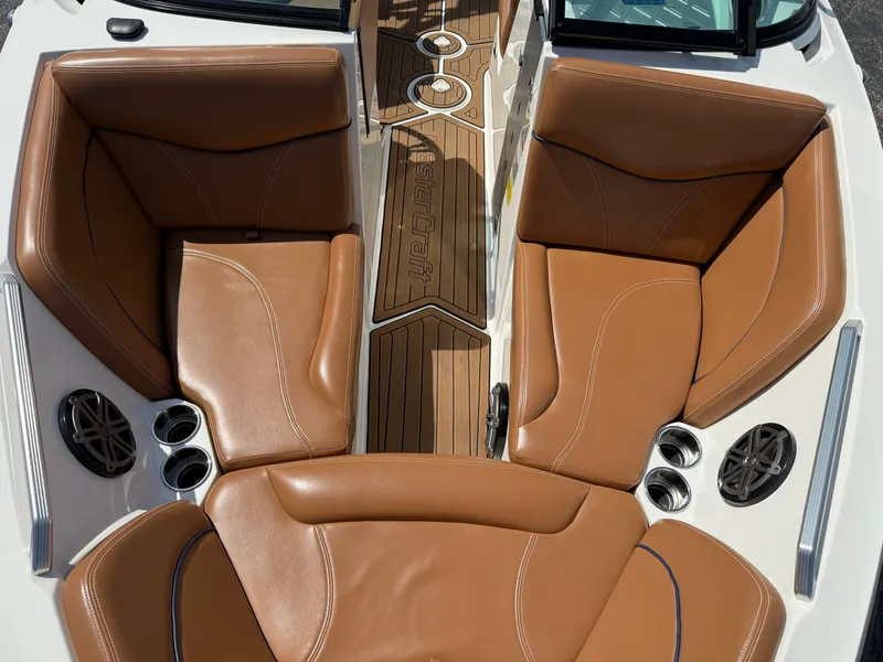 Slide: The Image of The image shows brown leather seats of a 2016 MasterCraft X30 with a wooden floor. - 33