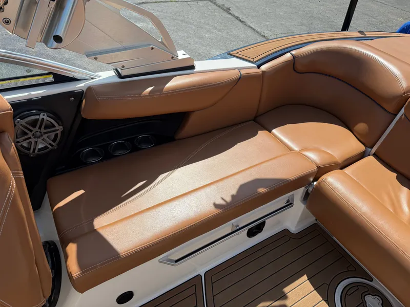 Slide: The Image of The image shows the brown leather seating of a 2016 MasterCraft X30 with speakers and cup holders. - 32