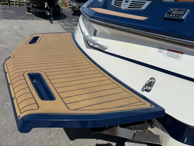 Slide: The Image of The image shows the stern of a 2016 MasterCraft X30 with a large swim platform. - 21