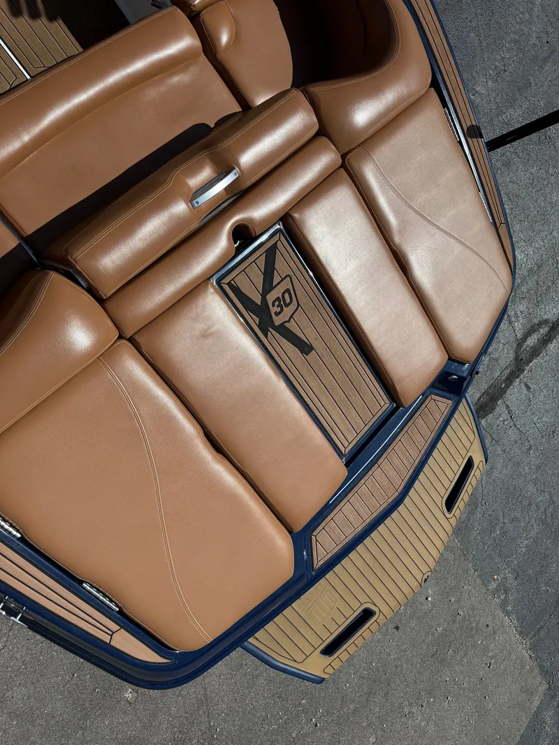 Slide: The Image of Brown upholstery on a 2016 MasterCraft X30 boat, featuring a stylish design. - 26