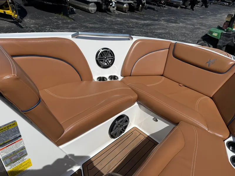 Slide: The Image of The image shows the bow area of a 2016 MasterCraft X30 with brown leather seating. - 38