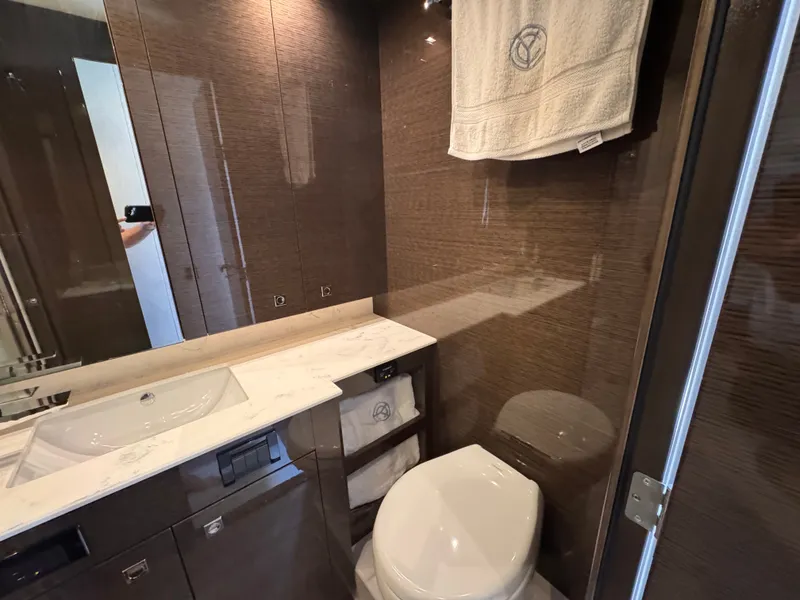 Slide: The Image of Luxurious bathroom with modern fixtures, marble sink, and elegant wood paneling. - 28