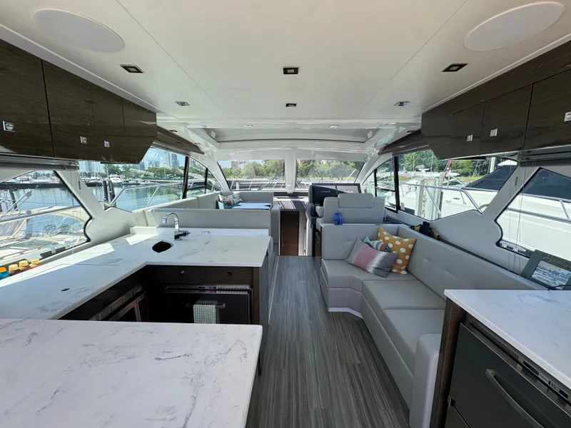 Slide: The Image of Interior view of a luxury yacht with a modern kitchen and cozy living area. - 7