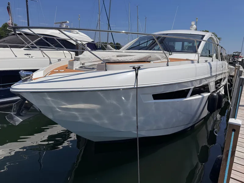 Slide: The Image of A luxurious motor yacht docked, featuring a sleek white hull and modern lines. - 2