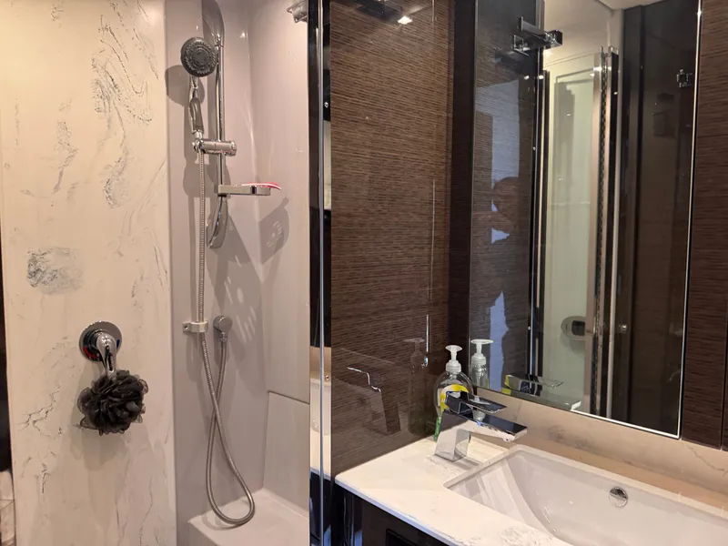 Slide: The Image of Bathroom with modern shower, marble walls, and sink in a luxurious yacht. - 26