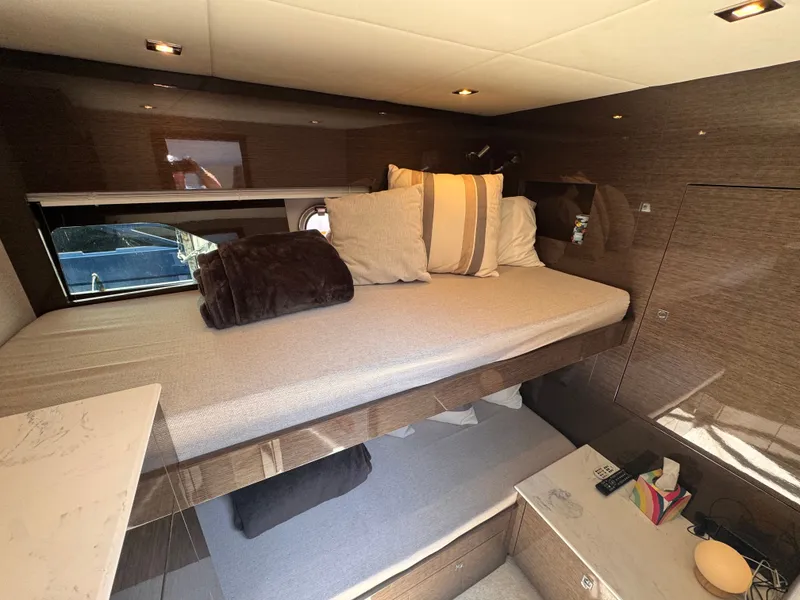 Slide: The Image of Cabin of the 2021 Cruisers Yachts 50 Cantius with bunk bed, pillows, and blankets. - 35