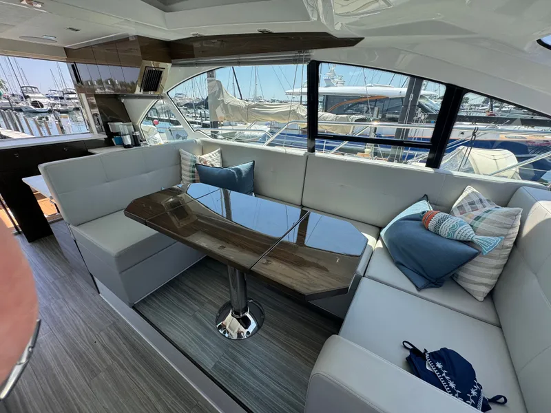 Slide: The Image of Interior of a luxury yacht with sleek white sofas and a glossy wooden table. - 19