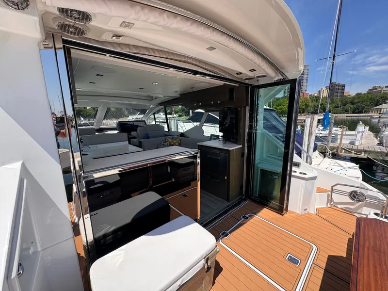 Slide: The Image of The 2021 Cruisers Yachts 50 Cantius features a sleek interior with an open living area and modern amenities. - 6