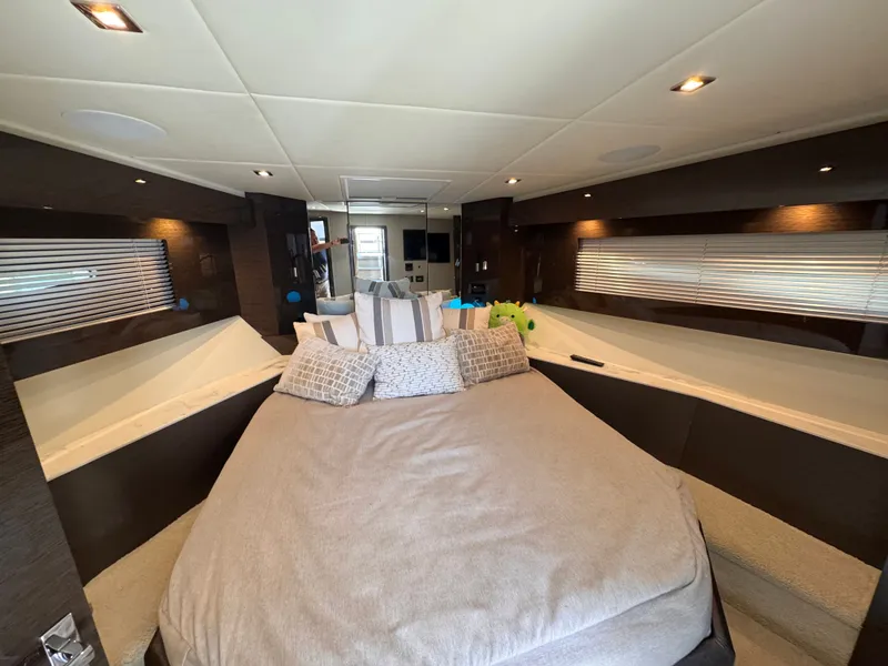 Slide: The Image of The image shows a luxurious cabin with a large bed, surrounded by elegant wood accents and modern lighting. - 29