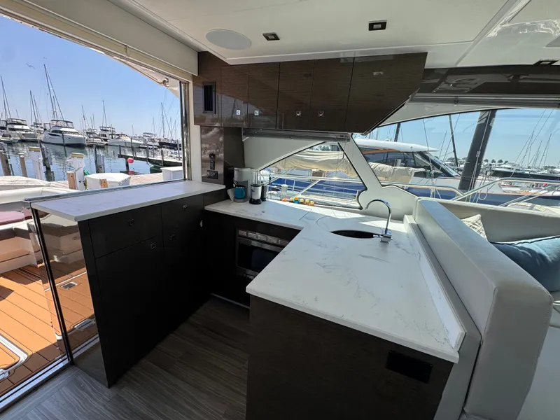 Slide: The Image of The galley of a 2021 Cruisers Yachts 50 Cantius with modern appliances and marina view. - 8