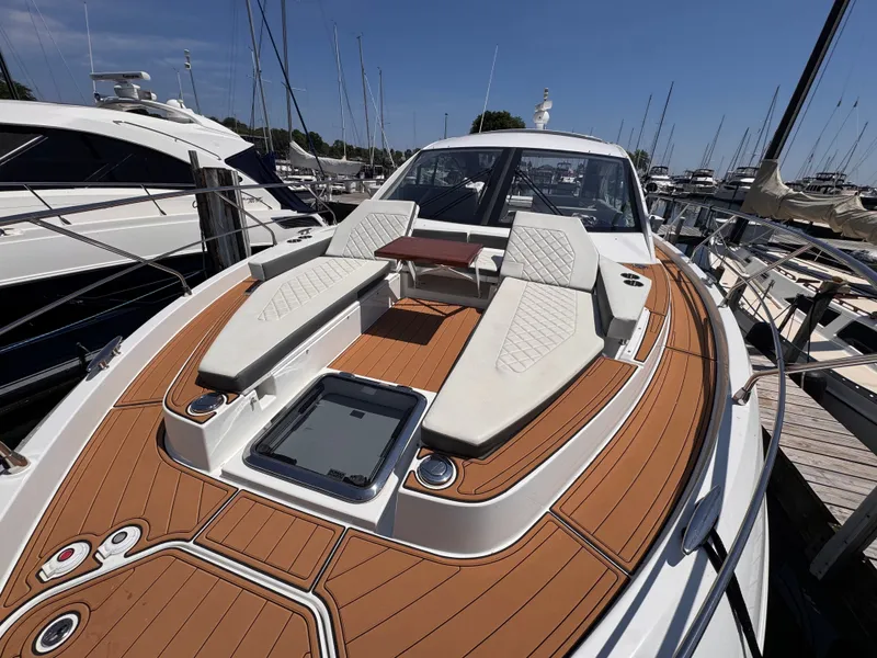 Slide: The Image of The image shows the foredeck of a 2021 Cruisers Yachts 50 Cantius with sleek lounging areas. - 45