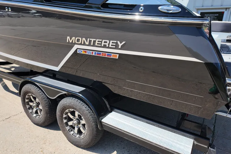 Slide: The Image of 2017 Monterey 258SS Super Sport boat on trailer, featuring sleek black design and dual axles. - 4