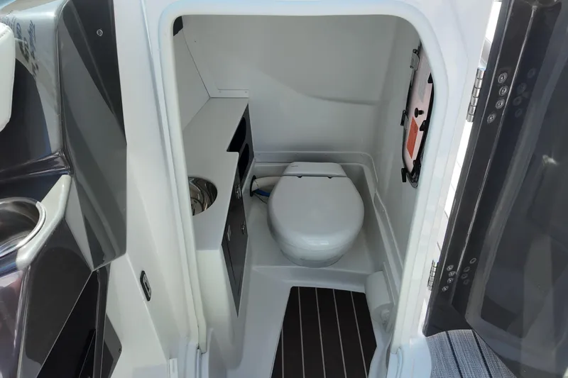 Slide: The Image of Interior view of 2017 Monterey 258SS Super Sport boat bathroom with toilet and storage. - 23