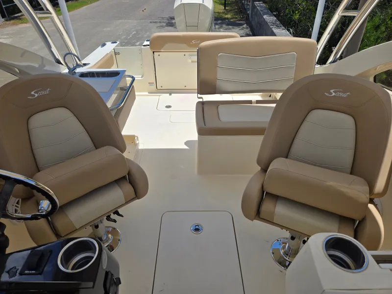 Slide: The Image of The image shows the interior of a Scout 240 Dorado boat with beige seating. - 8