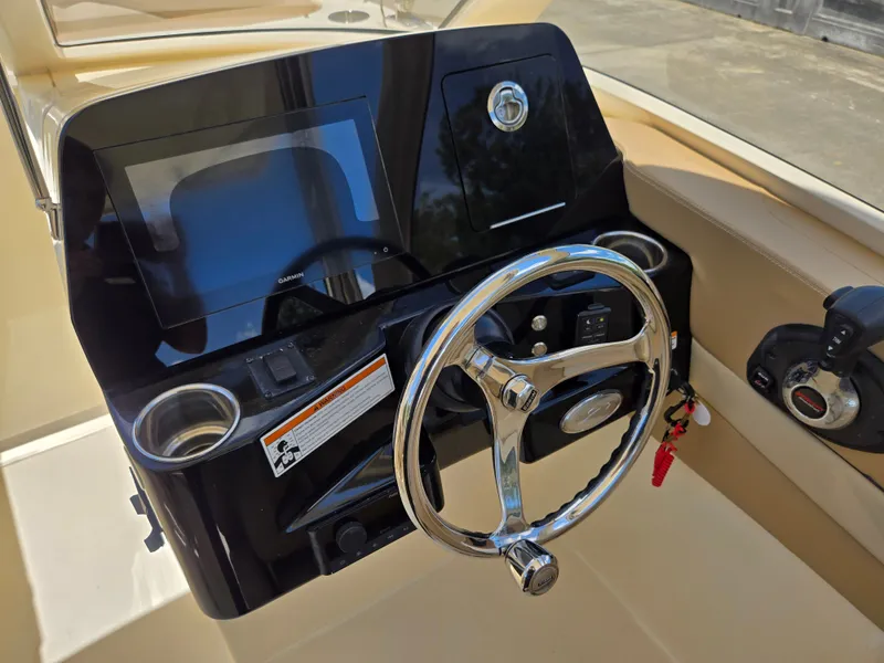 Slide: The Image of The image shows the helm of a 2022 Scout 240 Dorado boat. - 13