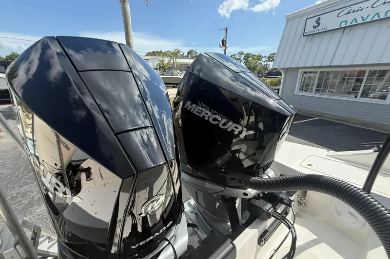 Slide: The Image of Twin Mercury outboard engines on a Navan S30 boat, 2026 model, in a sunny marina. - 18