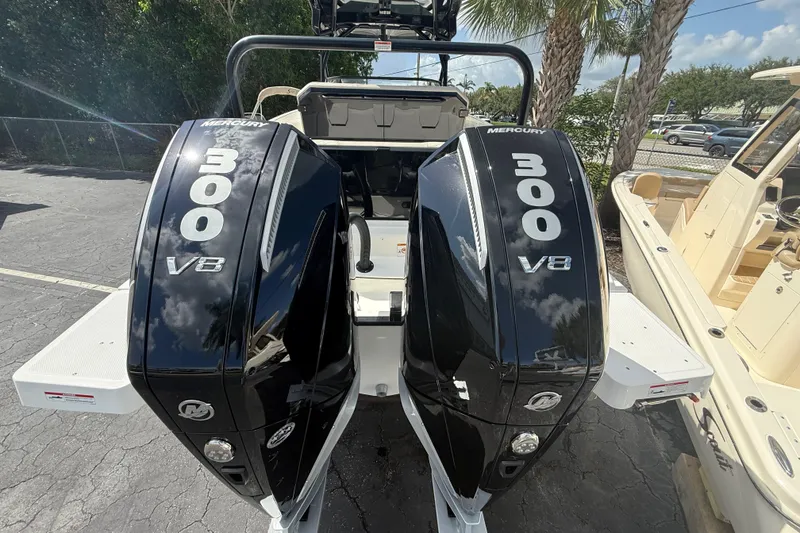 Slide: The Image of Twin Mercury 300 V8 engines on a 2026 Navan S30 boat, parked outdoors. - 19