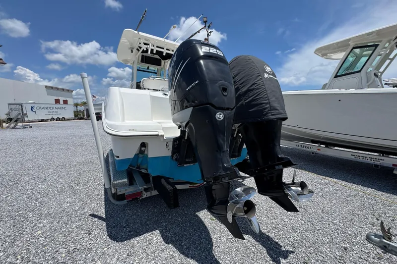Slide: The Image of 2014 Boston Whaler 250 Outrage with dual outboard engines on a trailer. - 14