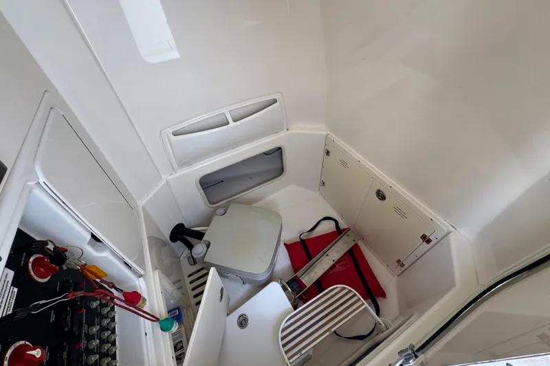 Slide: The Image of Interior of 2014 Boston Whaler 250 Outrage boat, featuring storage and equipment. - 25