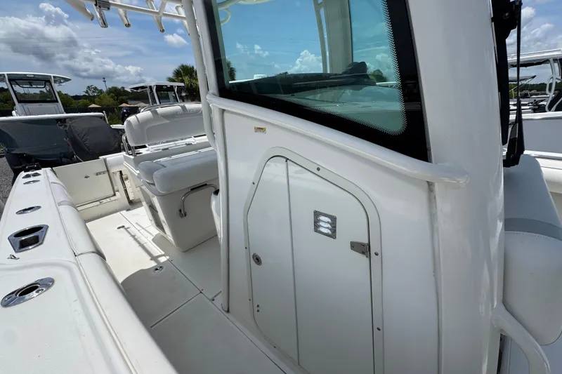 Slide: The Image of 2014 Boston Whaler 250 Outrage boat interior, featuring seating and storage compartments. - 24