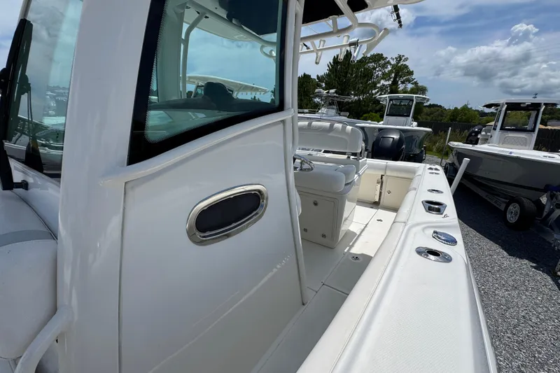 Slide: The Image of 2014 Boston Whaler 250 Outrage boat interior, showcasing seating and deck features. - 23