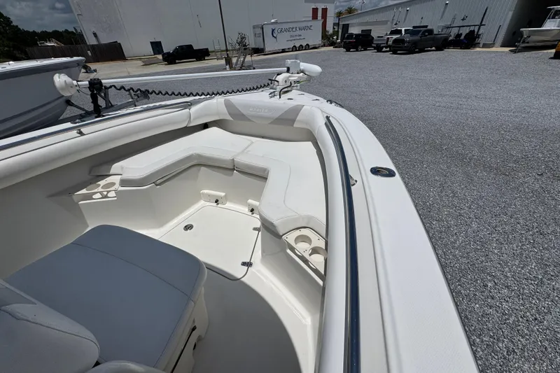 Slide: The Image of 2014 Boston Whaler 250 Outrage boat interior with seating and cup holders. - 16
