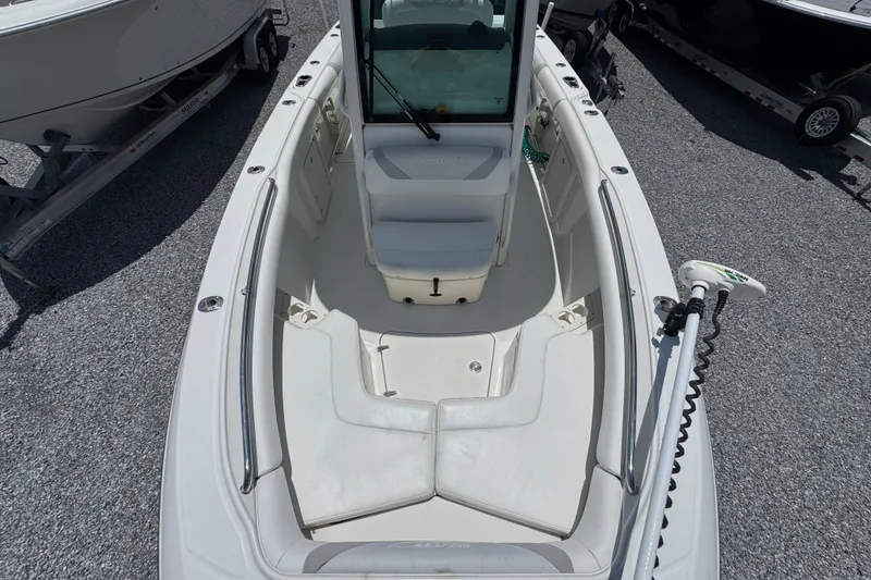 Slide: The Image of 2014 Boston Whaler 250 Outrage boat interior with seating and fishing equipment. - 20