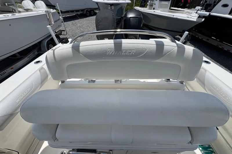 Slide: The Image of 2014 Boston Whaler 250 Outrage boat interior with white seating and logo detail. - 31