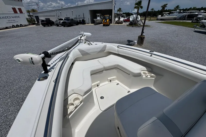 Slide: The Image of 2014 Boston Whaler 250 Outrage boat interior with seating and trolling motor. - 18