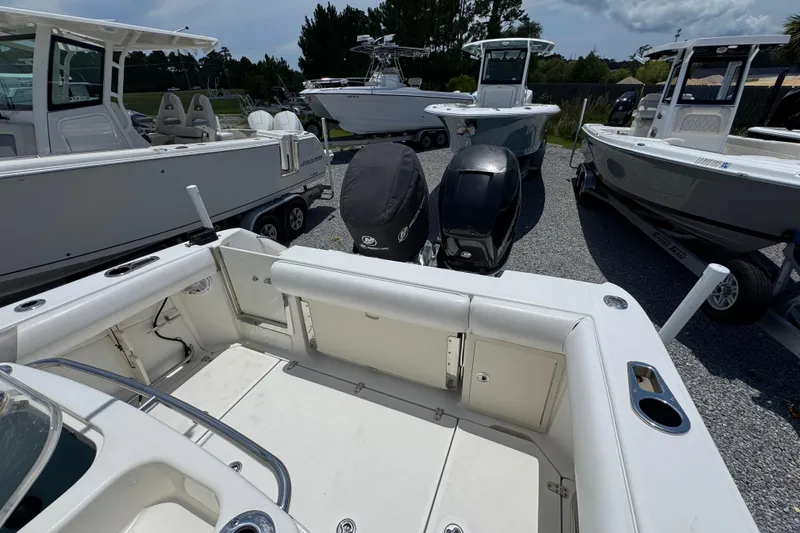 Slide: The Image of 2014 Boston Whaler 250 Outrage boat with dual engines, parked among other boats. - 36