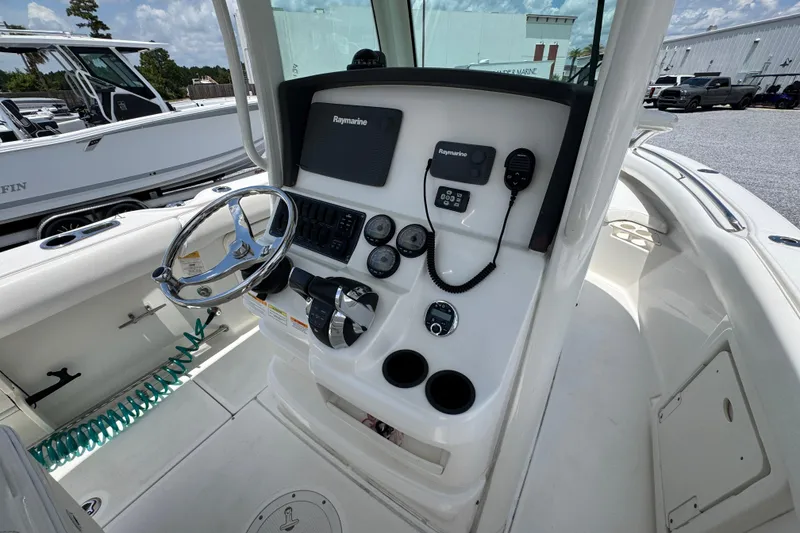 Slide: The Image of 2014 Boston Whaler 250 Outrage boat console with steering wheel and Raymarine electronics. - 29